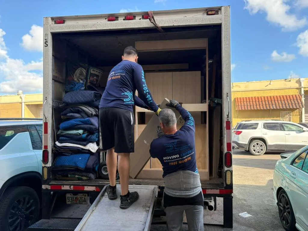 DY Moving crew in company shirts loading furniture into the truck